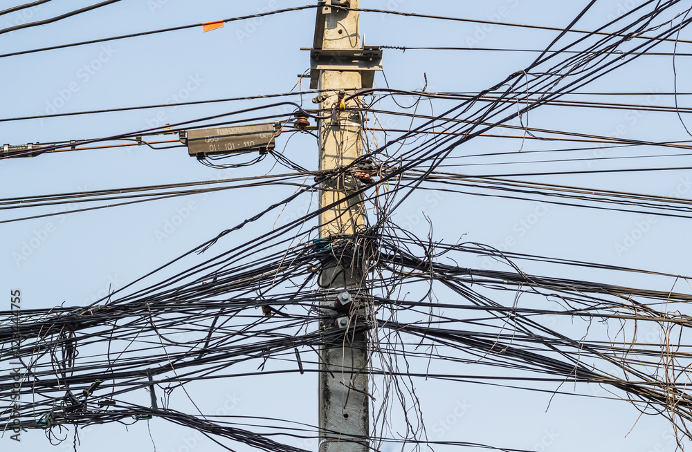 Messy electrical cables and wires on electric pole. Messy electrical cables and wires on electric pole.
