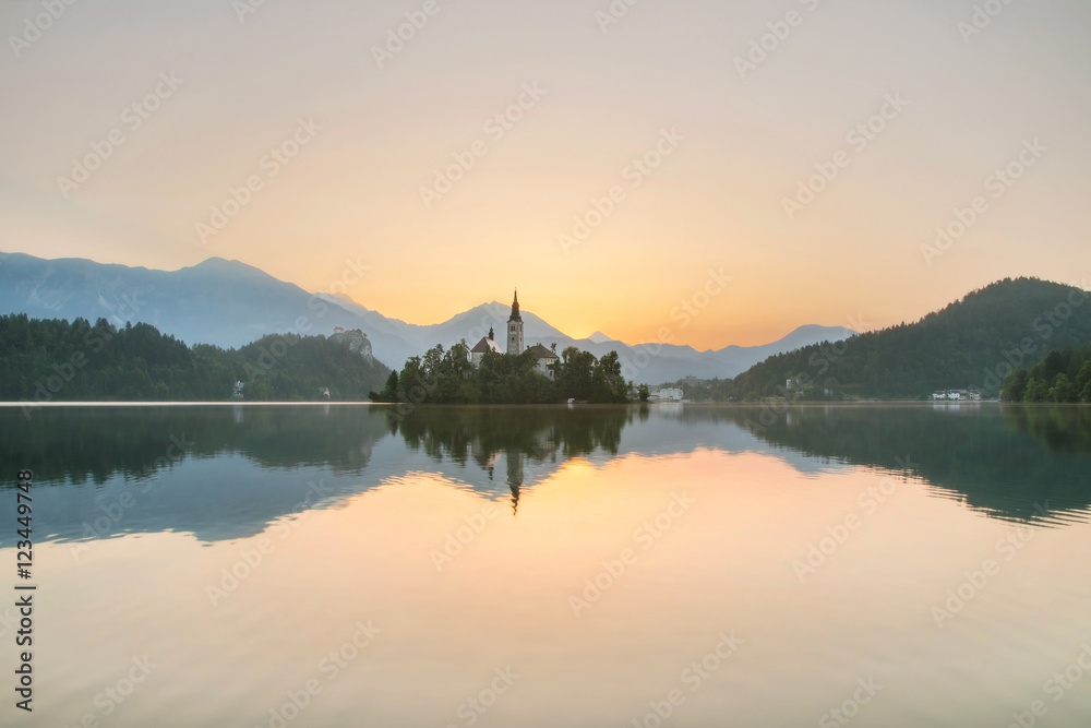 Lake Bled at dawn with island and castle in Slovenia