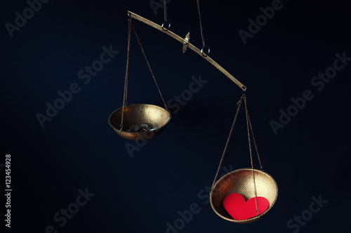 Old fashioned scale showing the advantage of love over money