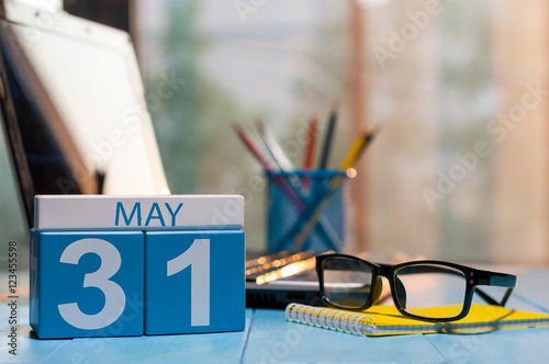 May 31st. Day 31 of month, calendar on business office background, workplace with laptop and glasses. Spring time, empty space for text