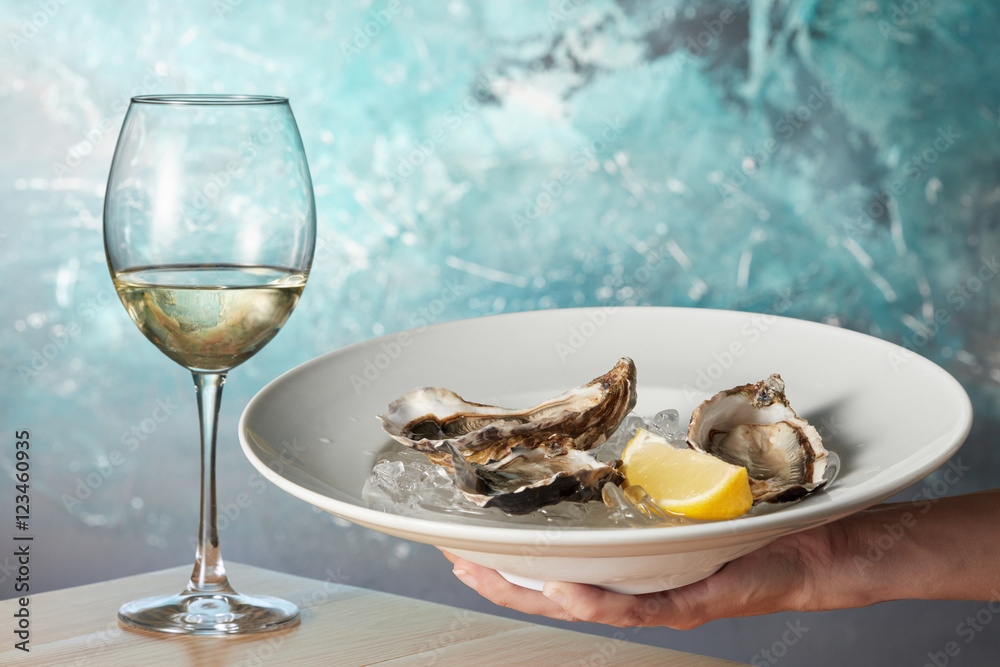 Oysters in a white plate with lemon Oysters in a white plate with lemon