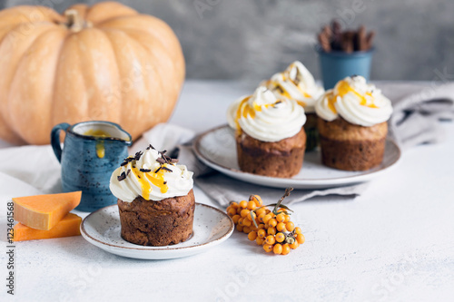 Pumpkin muffin decorated with cream cheese topping, chocolate an
