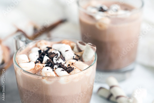 Two glass cups of hot cocoa served with marshmallow – close up
