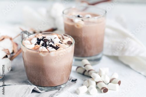 Two glass cups of hot cocoa served with marshmallow – close up