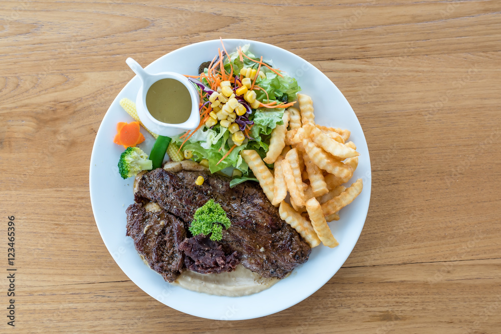 deer meat steak served with french fries and salad deer meat steak served with french fries and salad