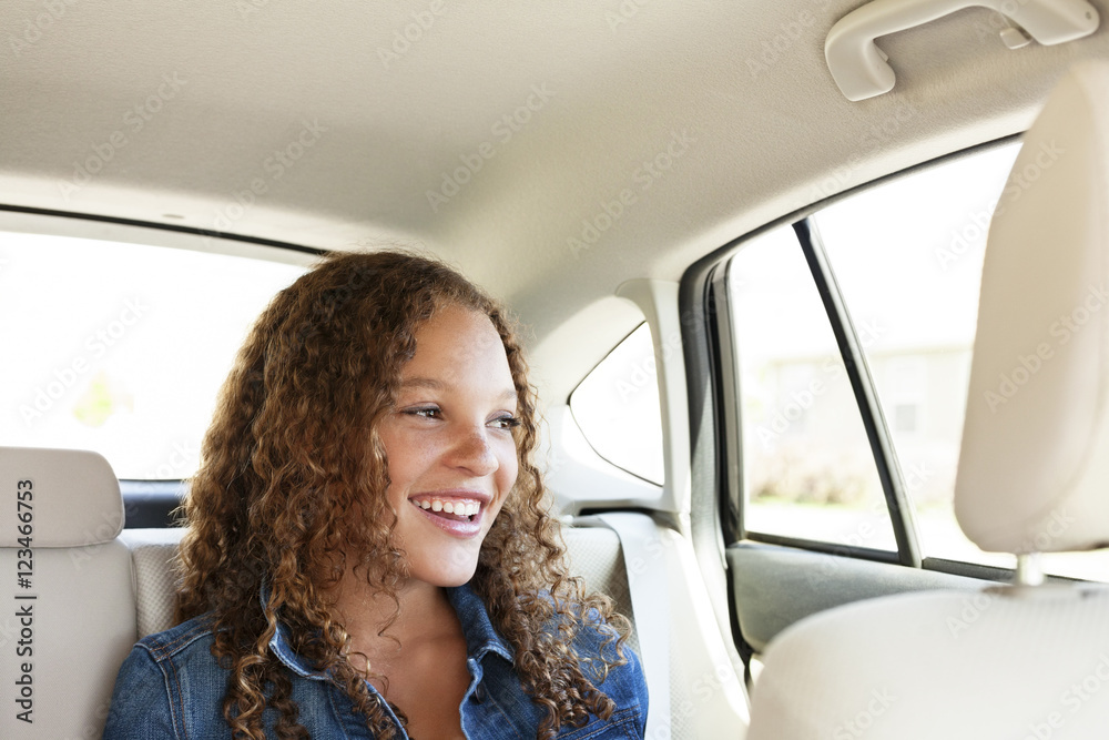 Happy teenager looking away while sitting in car Happy teenager looking away while sitting in car