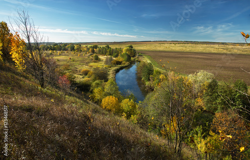 Rural landscape with a small river in autumn
