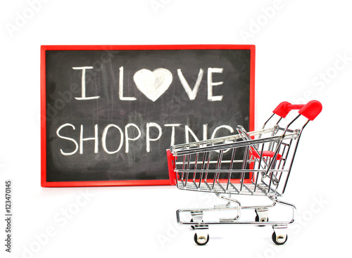 Shopping cart with chalk written word "I Love Shopping" on black