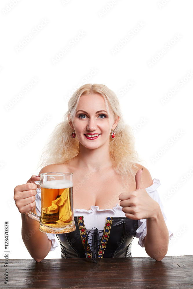Beautiful young blond girl in traditional costume drinks out of oktoberfest beer stein. Beautiful young blond girl in traditional costume drinks out of oktoberfest beer stein.