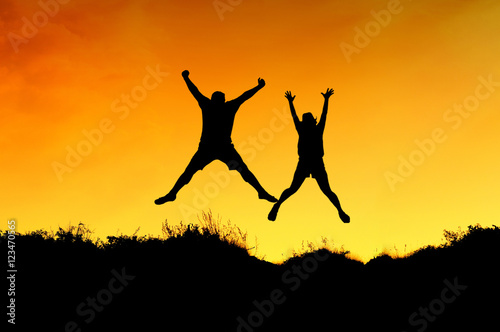a couple jump on the top of mountain and getting fun on mountains backdrop photo