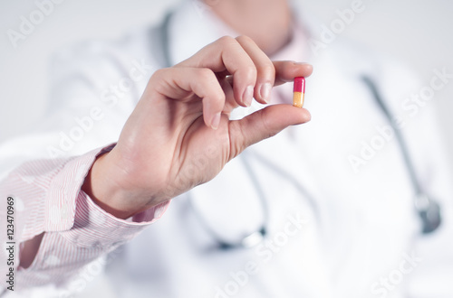 Closeup of one pill in doctor hands