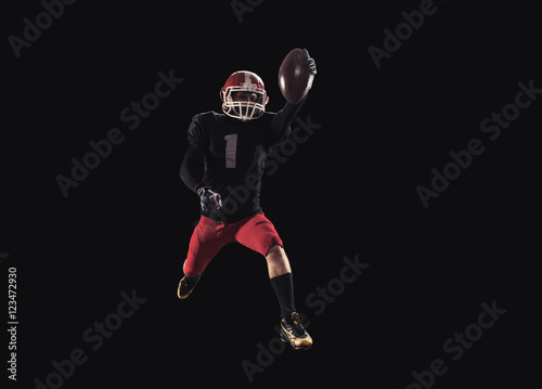 Football player on dark background