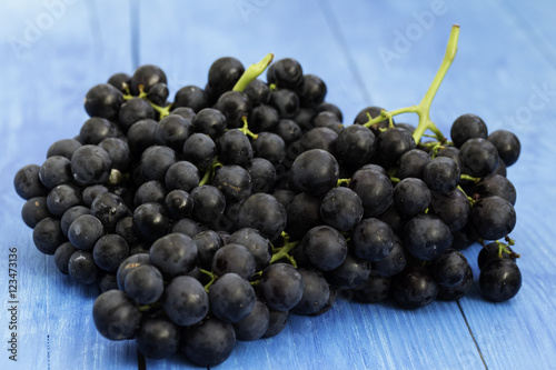 Black grapes on wooden background
