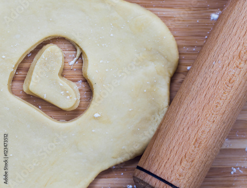 Homemade heart shaped pastry on the wooden board photo