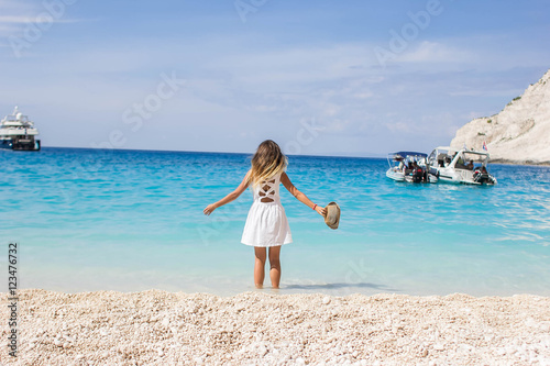 girl in white relax on Navagio beach.beach holidays