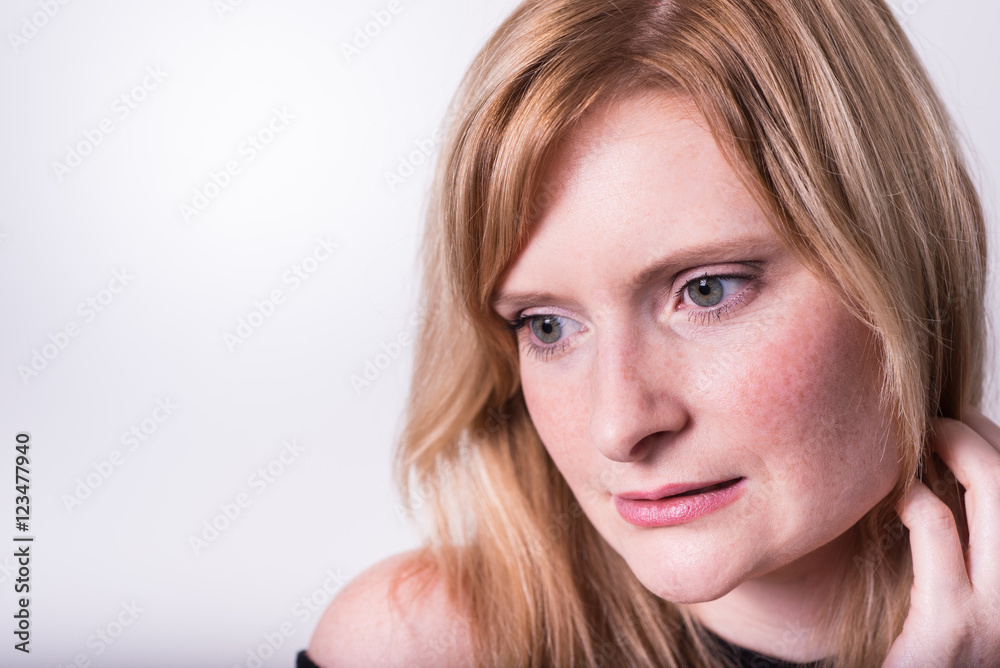 beautiful blonde woman looking down and dreaming beautiful blonde woman looking down and dreaming
