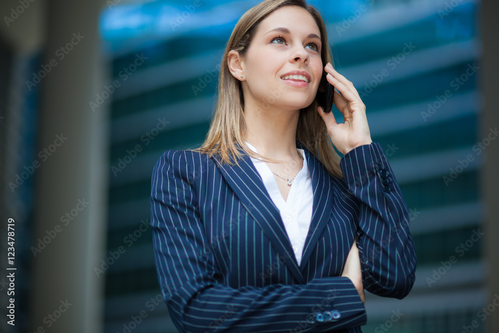 Portrait of a young woman talking on the phone Portrait of a young woman talking on the phone
