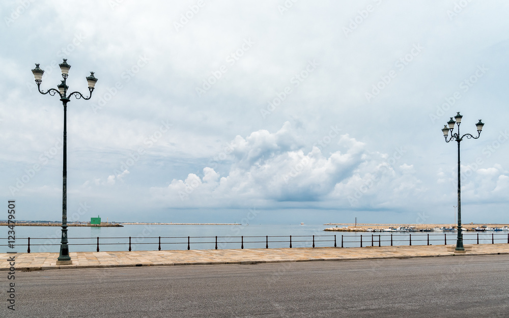 Seascape in cloudy weather with side street lamp. Meditation concept. Postcard or background.