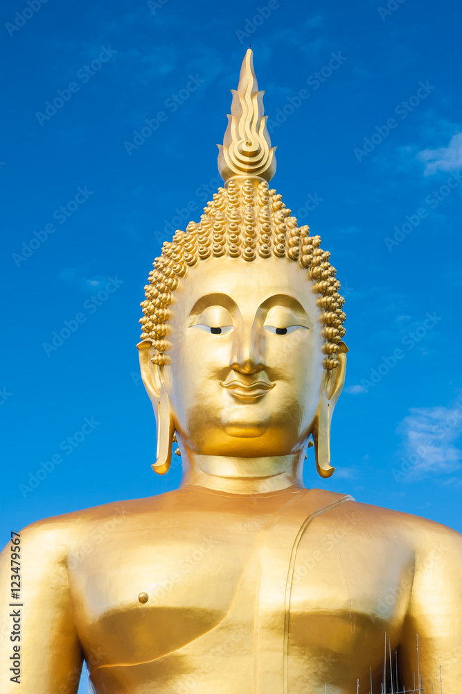 closeup beautiful golden Buddha statue with blue sky background. closeup beautiful golden Buddha statue with blue sky background.