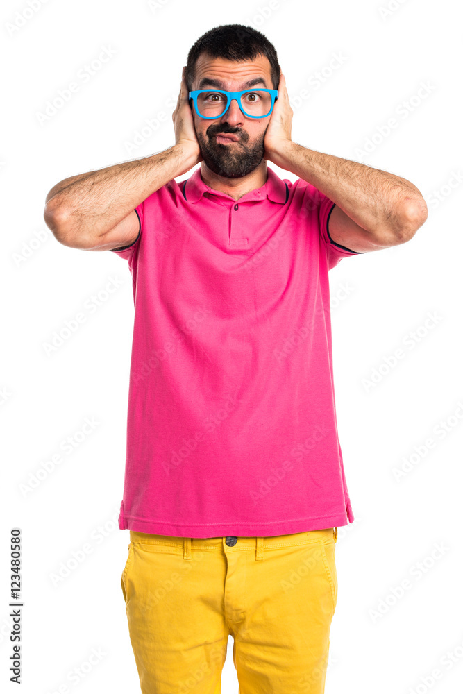Fototapeta premium Man with colorful clothes covering his ears
