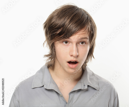Surprised teenager in grey shirt