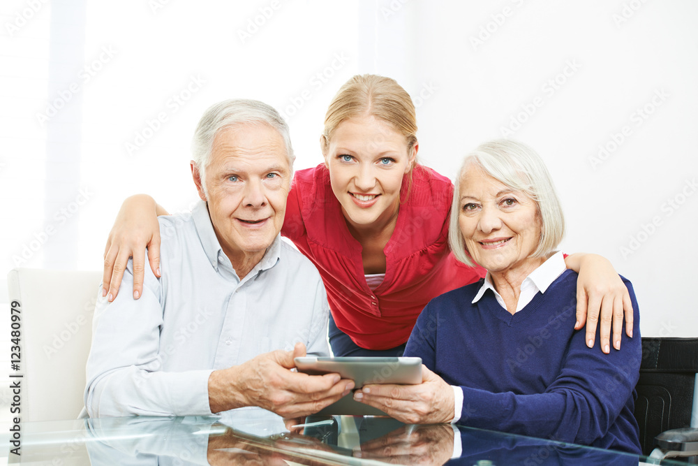 Family with senior couple and tablet computer