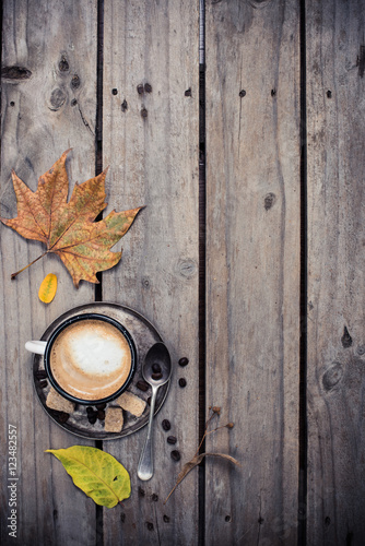 Cozy autumn, cup of coffee and yellow leaves