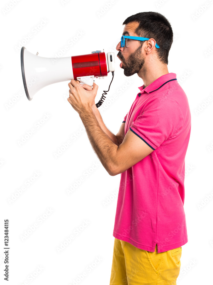 Man with colorful clothes shouting by megaphone Man with colorful clothes shouting by megaphone