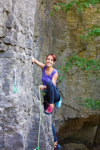 The girl climbs the rock.