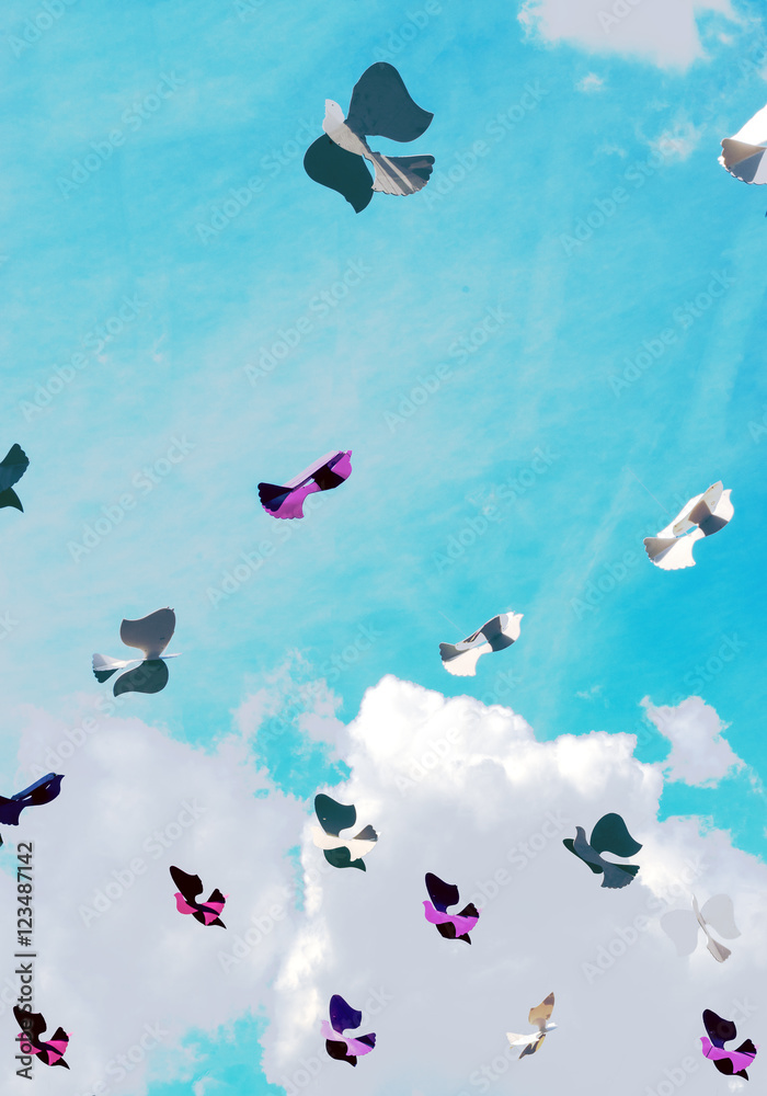 Fototapeta premium Paper bird in the sky with clouds