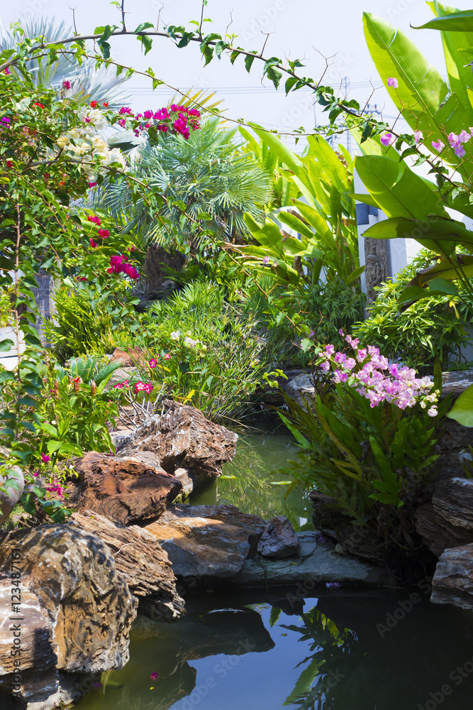 Summer tropical landscape with garden in bloom