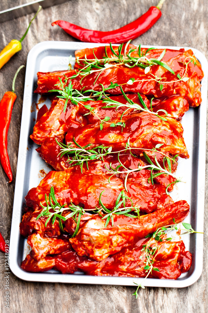 Raw marinated pork ribs on metal tray. Ready for BBQ Raw marinated pork ribs on metal tray. Ready for BBQ