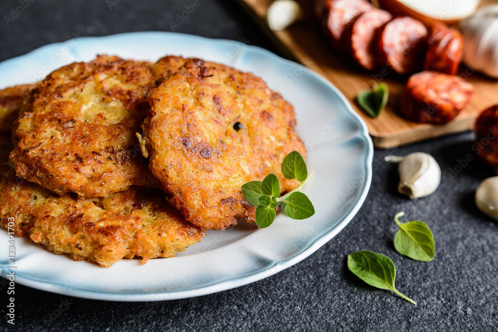 Fried sour cabbage pancakes with potato and sausage