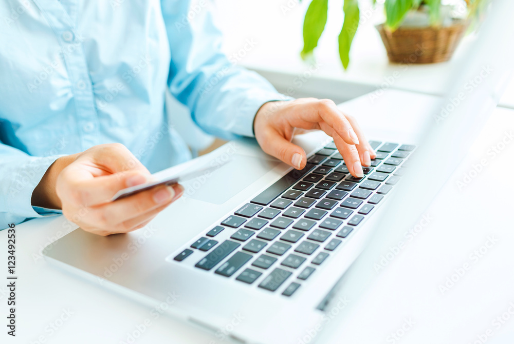Hands using laptop and credit card Hands using laptop and credit card