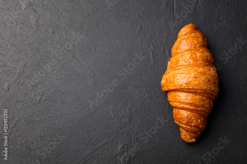 Obraz na płótnie Fresh croissant on a black slate background.