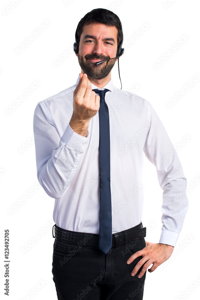 Young man with a headset doing money gesture Young man with a headset doing money gesture