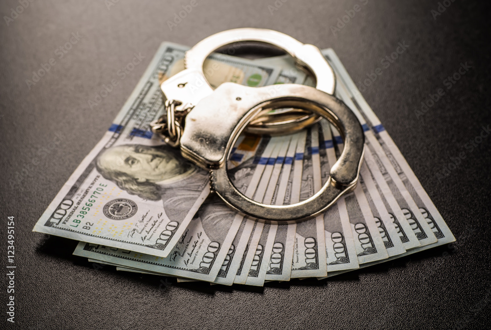 Handcuffs and money on the table Handcuffs and money on the table