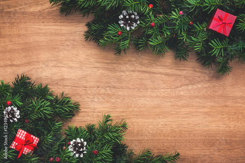 Christmas tree twigs and presents on wooden floor. Christmas background.