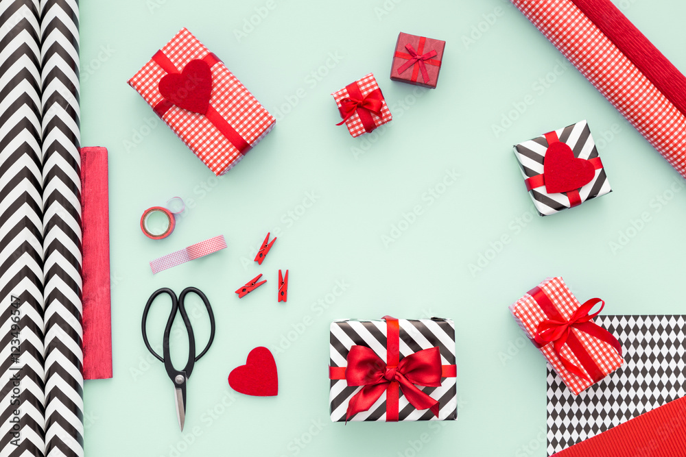 Gift boxes wrapped in red checked paper on a mint color table. Preparing presents. Copy space. Gift boxes wrapped in red checked paper on a mint color table. Preparing presents. Copy space.
