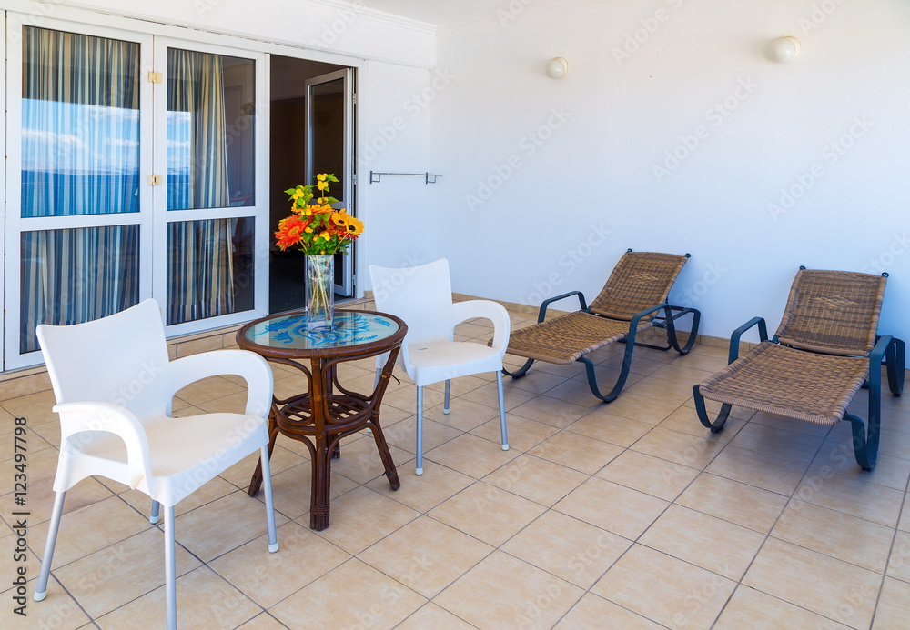 Interior of new apartment, veranda with two sunbeds