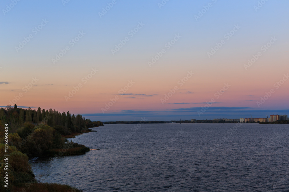 Sunset blue and pink sky, lake, forest green, landscape, background Sunset blue and pink sky, lake, forest green, landscape, background