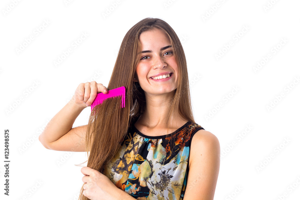 Young woman brushing her long hair Young woman brushing her long hair