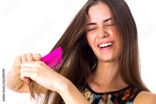 Young woman brushing her long hair 