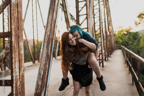 Girls giving piggy back to each other.