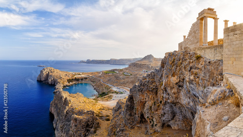 Greece. Rhodes. Acropolis of Lindos. Doric columns  the ancient Temple  Athena Lindia the IV century BC and the bay  St. Paul