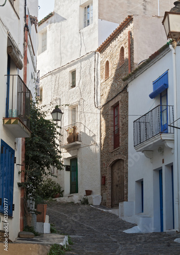 narrow street with white houses in historical center of Cadaques  spain