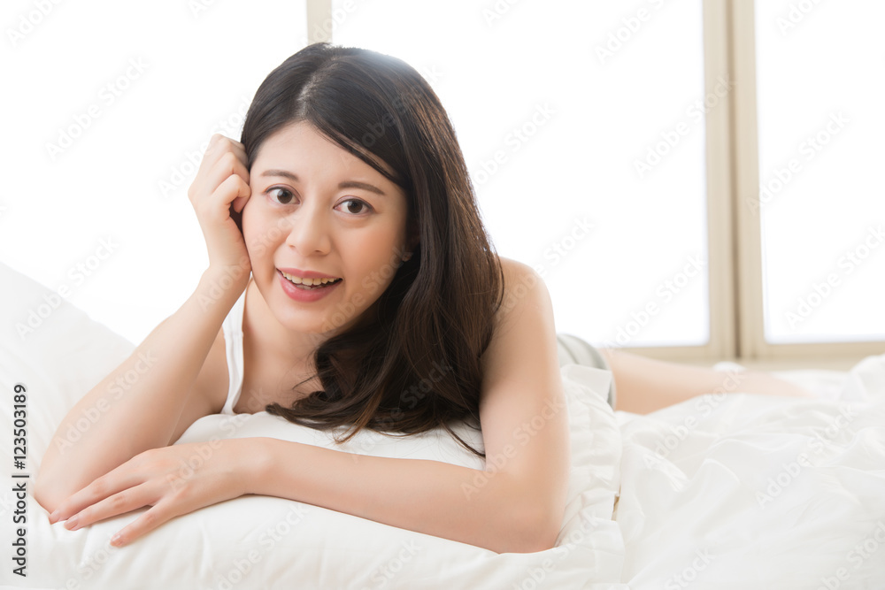 happy beautiful health asian woman feel carefree lying on bed happy beautiful health asian woman feel carefree lying on bed