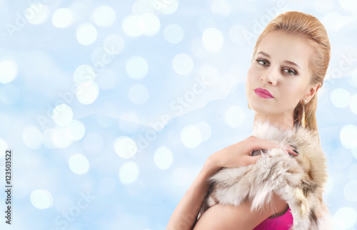 Elegant woman in fur cape o...