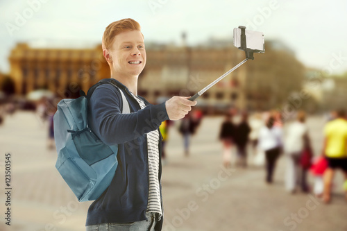 Young man taking selfie on ...