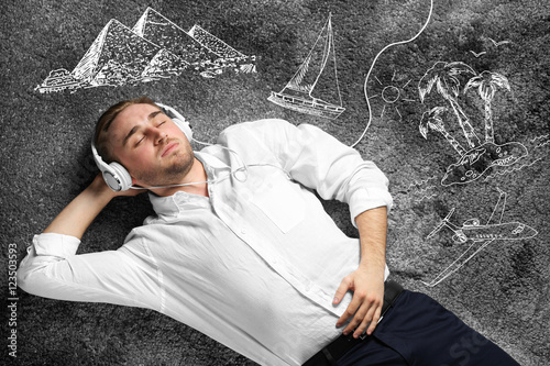 Young man lying on carpet a...